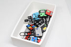 Catchall Studio BitTray H1 3D‑printed tray holding assorted retro gaming‑style paperclips arranged on a white background.