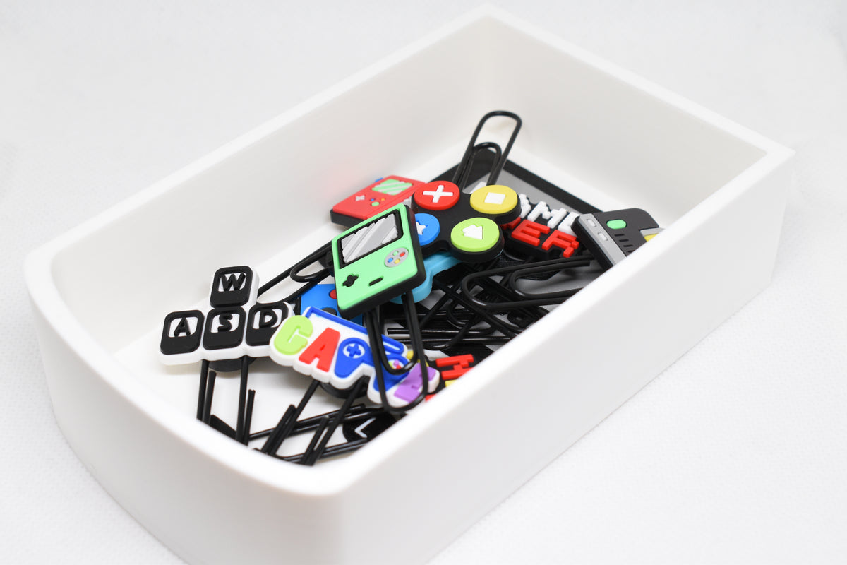 Catchall Studio BitTray V1 3D‑printed tray holding assorted retro‑style gaming and computer‑themed paperclips on a white background.