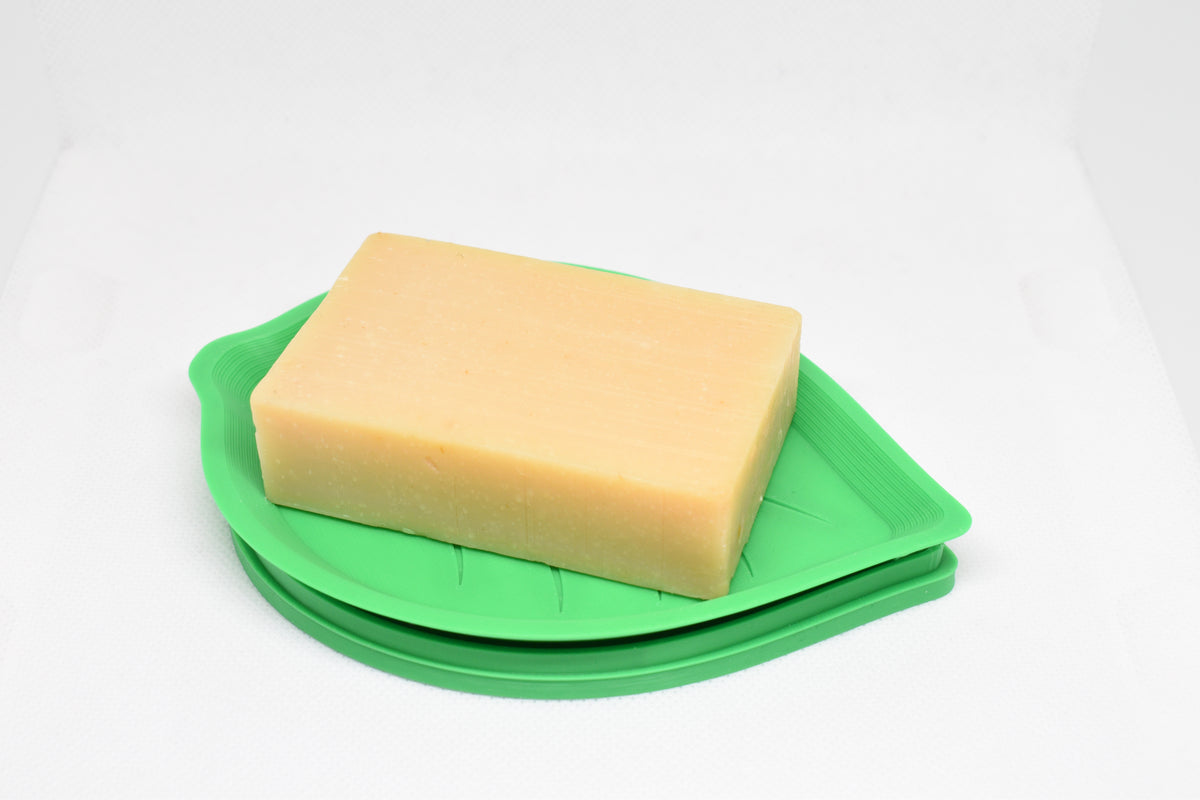 Solara Series FloraDrain Soap Dish holding a rectangular bar of soap on a white background, featuring its leaf‑shaped 3D‑printed design and drainage holes.