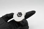 Gloved hand demonstrating the back base plate of the FrostyClick fidget toy, featuring a face-down textured plate finish and integrated Layerplay brand logo.