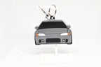 Gray Eclipse keychain displayed on a white stand with metal ring and clip.