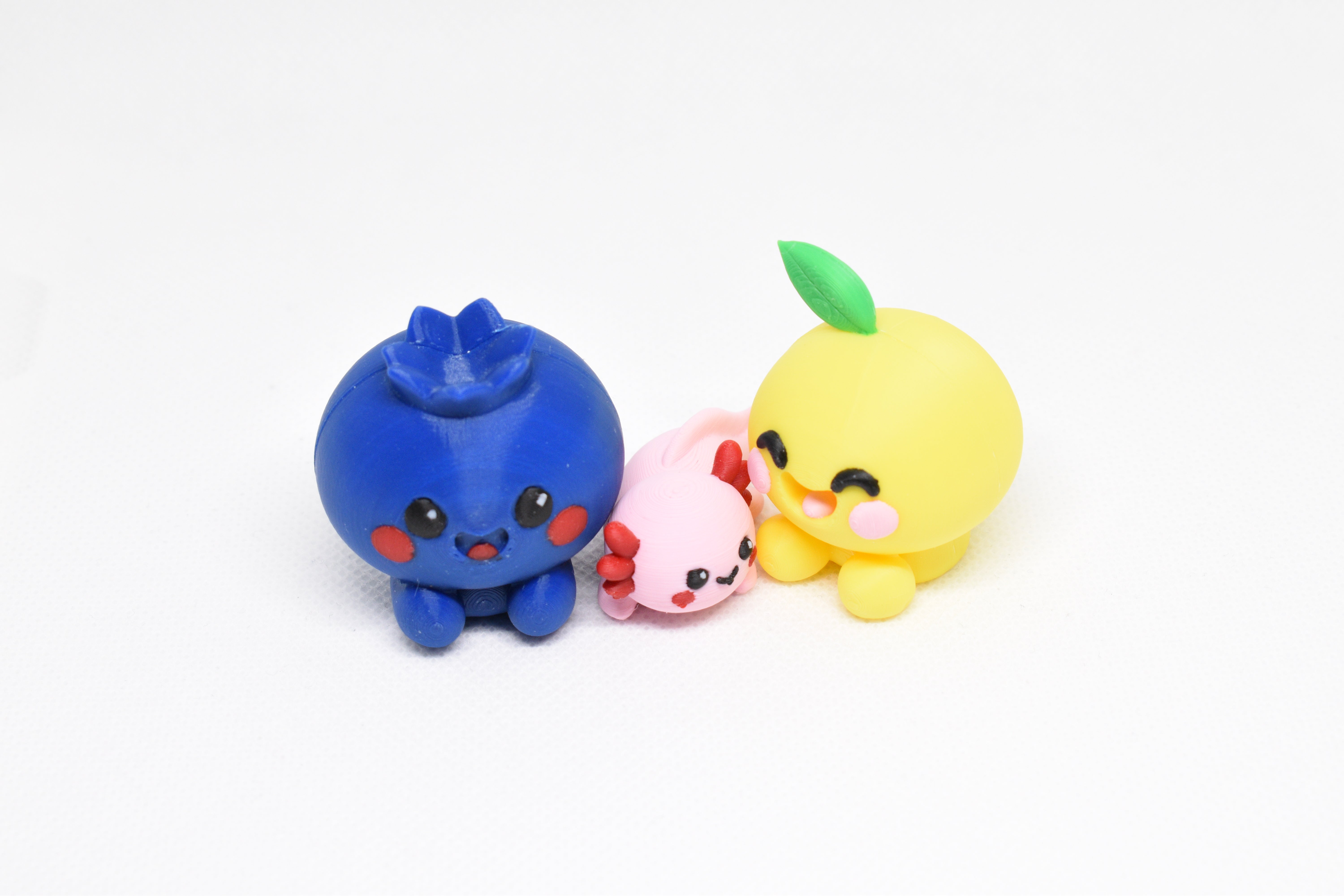 Kawaii Blueberry, Axolotl, and Lemon figurines arranged together on a white background.