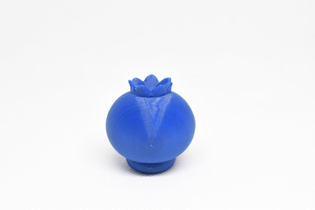 Rear view showing smooth 3D layers and top leaf crown structure of blue kawaii blueberry desk toy figure by LayerPlay
