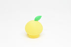 Rear view showing top green leaf texture and smooth finish of yellow kawaii lemon desk toy figure by LayerPlay
