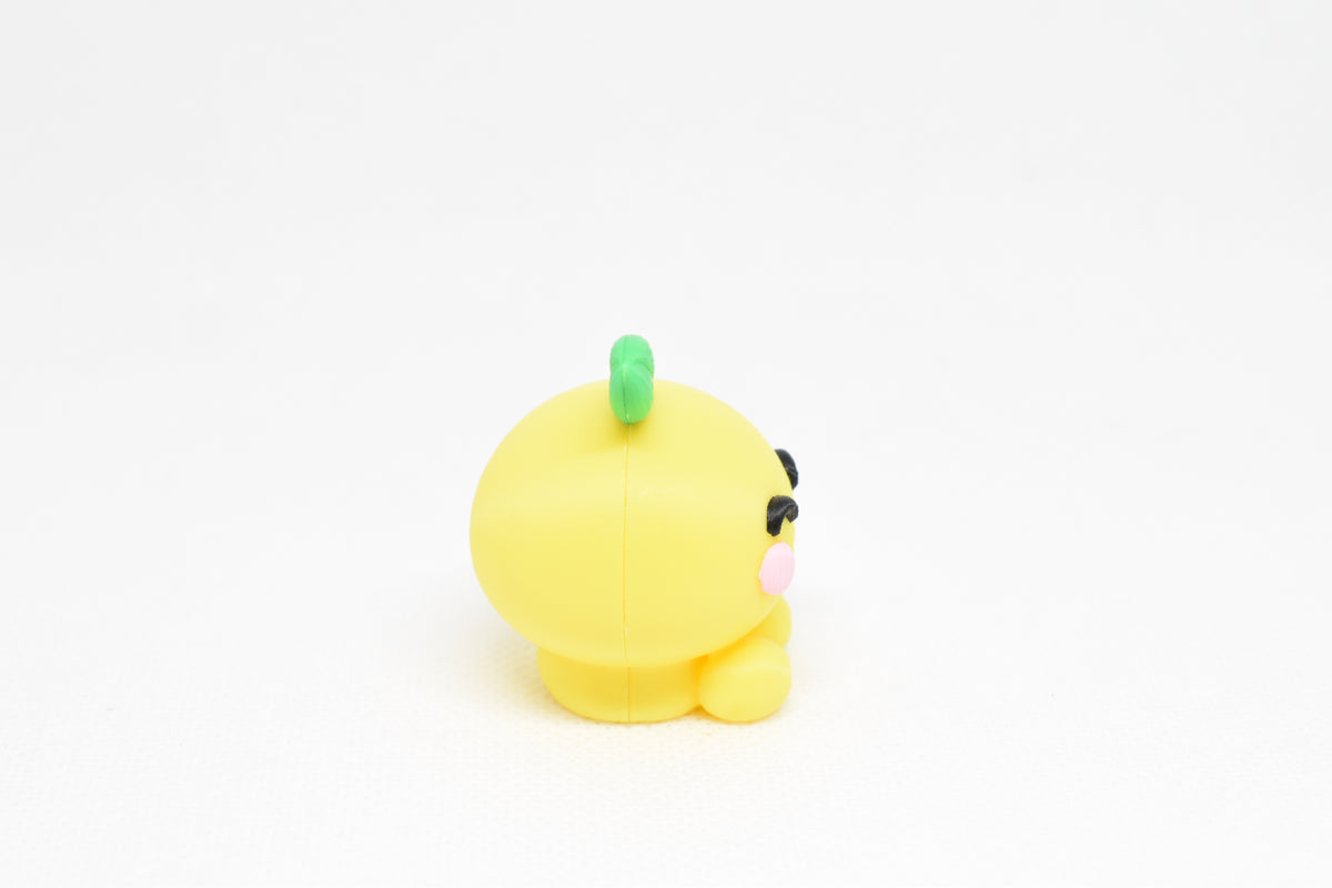 Side profile view showing round yellow body and green leaf detail of 3D printed kawaii lemon desk toy by LayerPlay