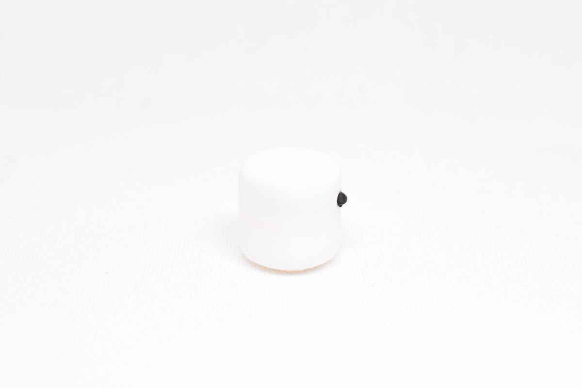 Side profile view showing round shape and smooth 3D printed finish of white kawaii marshmallow desk toy by LayerPlay