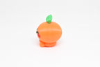 Side profile view showing round orange body and green leaf detail of 3D printed kawaii orange desk toy by LayerPlay