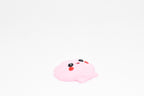 Low angle view of cute 3D printed kawaii seashell desk toy figure resting on a white background by LayerPlay