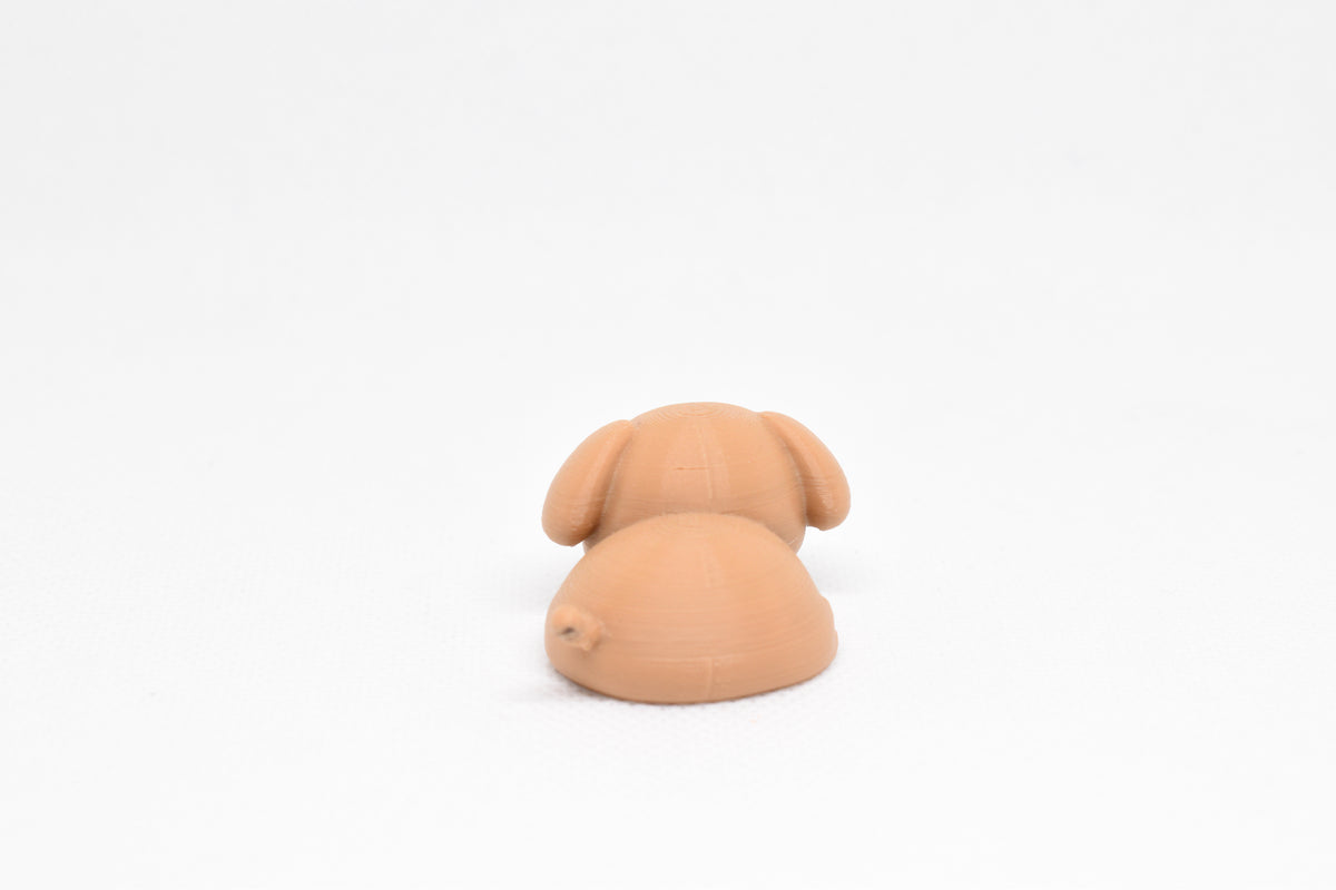 Rear view showing back body curves and tail detail of brown kawaii sleeping dog desk toy figure by LayerPlay