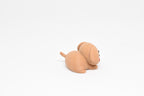 Side perspective view showing little tail and body shape of 3D printed kawaii sleeping dog desk toy by LayerPlay