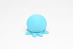 Low angle view of cute 3D printed kawaii sleeping octopus desk toy figure resting on a white background by LayerPlay