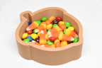 Angled top view of 3D printed brown acorn candy dish filled with candy corn and Skittles by LayerPlay Layertreat