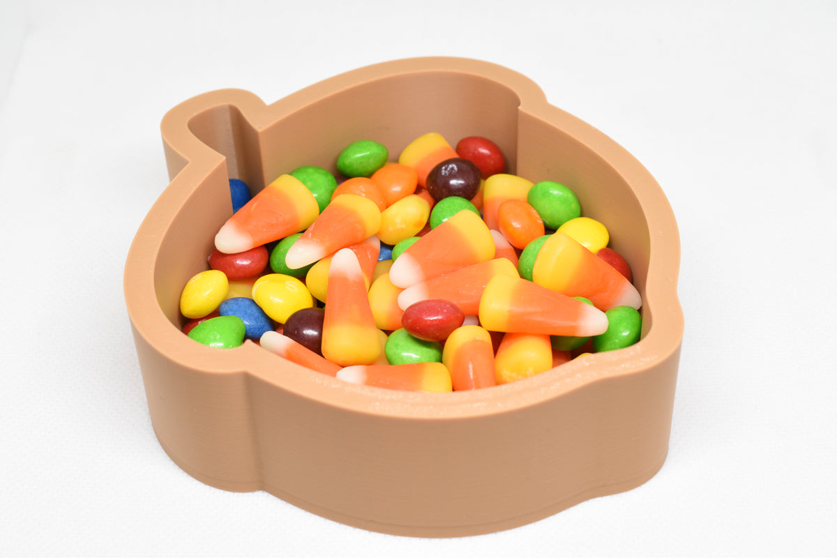 Angled top view of 3D printed brown acorn candy dish filled with candy corn and Skittles by LayerPlay Layertreat