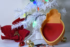 Layertreat BulbBowl red and gold Christmas light bulb 3D printed candy dish set up in a holiday tree display with red poinsettia and ornaments.