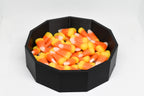 Angled studio view of 3D printed black spider web candy dish filled with candy corn for Halloween decor by LayerPlay Layertreat