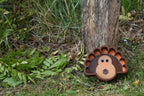 3D printed turkey candy dish resting against a wooden garden fence, outdoor Thanksgiving table decor by LayerPlay Layertreat