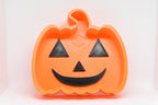 Top studio view of 3D printed orange octagonal JackBowl candy dish featuring orange jack-o'-lantern design by LayerPlay Layertreat