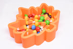 Angled top view of 3D printed orange maple leaf candy dish filled with candy corn and Skittles by LayerPlay Layertreat