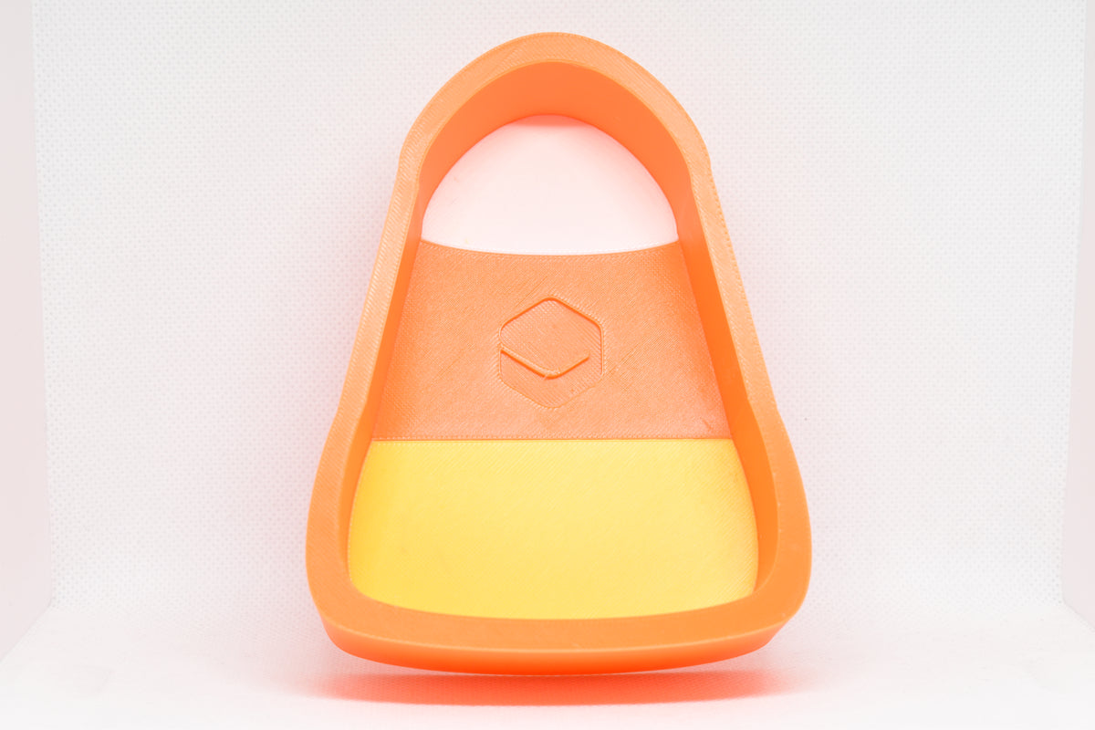 Front studio view showing 3D printed yellow orange and white candy corn shape design of TriCorn candy dish by LayerPlay Layertreat