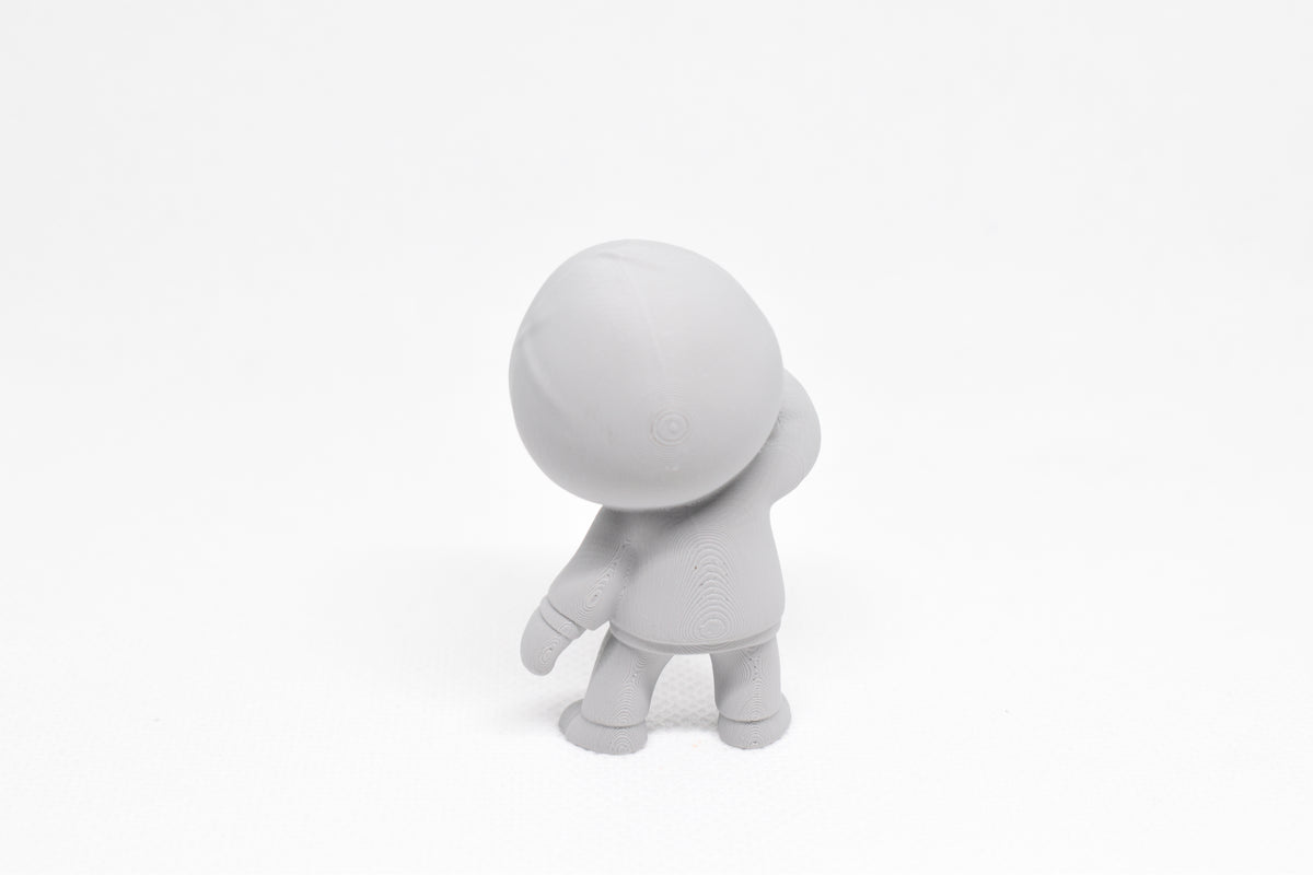 Rear view showing hooded sweatshirt detail and leaning pose of grey 3D printed monomoodz drift collectible figure by LayerPlay