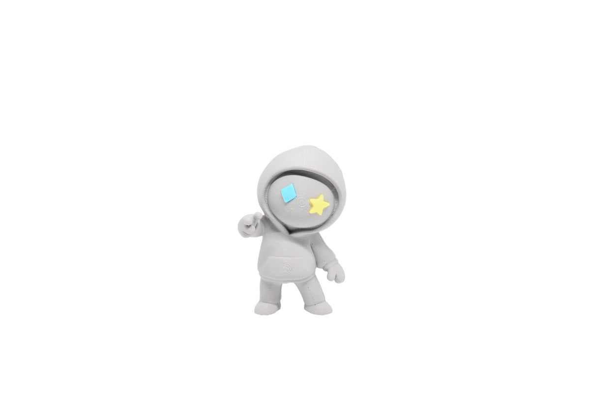 3D printed grey monomoodz drift desk figure with blue diamond eye, yellow star eye, hoodie, and peace sign gesture front view by LayerPlay