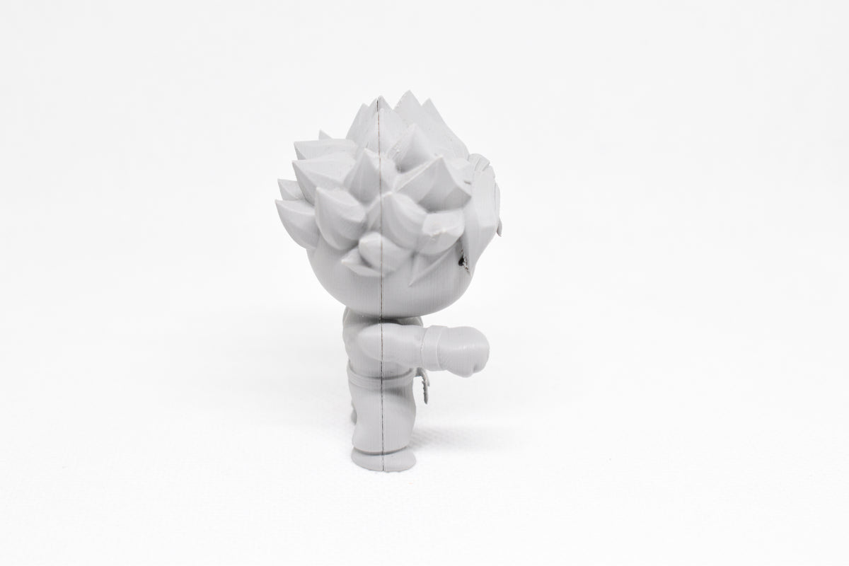 Side profile view showing extended fist stance and layered spiked hair of 3D printed monomoodz erix desk figure by LayerPlay
