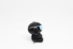 Side profile view showing black body, floppy dog ears, and glow in the dark eye detail of 3D printed monomoodz glyphie dog desk figure by LayerPlay
