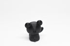 Rear view showing rounded bear ears and small tail of black 3D printed monomoodz glow in the dark twinkle figure by LayerPlay