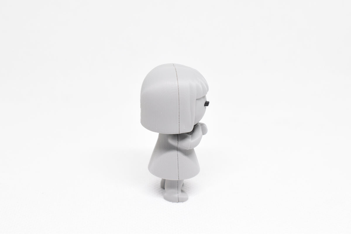 Side profile view showing bob haircut and folded arms pose of 3D printed monomoodz luma desk figure by LayerPlay