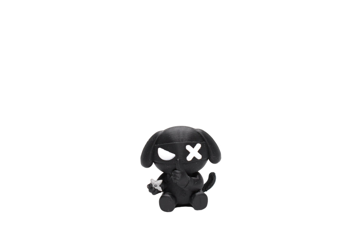 3D printed black monomoodz ninja glyphie dog desk figure with headband, white X eye, half-moon eye, floppy ears, and shuriken front view by LayerPlay