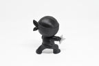 Rear view showing ninja cowl, headband tie, and low action stance of black 3D printed monomoodz shurikid collectible figure by LayerPlay