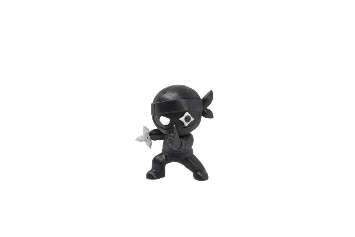 3D printed black monomoodz shurikid ninja desk figure holding silver throwing star in stealth action pose front view by LayerPlay