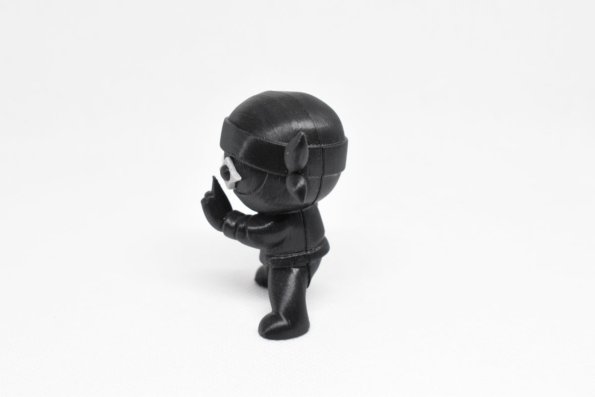 Side profile view showing tied headband knot and shuriken eye detail of 3D printed monomoodz shurikid desk figure by LayerPlay