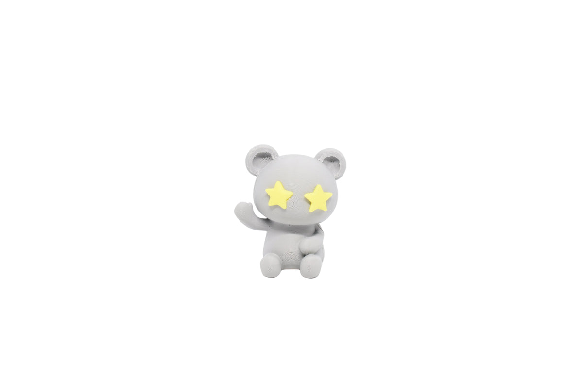 3D printed grey monomoodz twinkle bear desk figure with yellow star eyes waving hand front view by LayerPlay