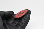 Side angle view showing 3D layered pixel detail and thickness of red pixelated angry emoji keychain by LayerPlay