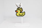 3D printed retro Ascended Duck pixel rubber duck keychain hanging on a white display stand by LayerPlay