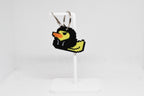 3D printed retro Hoodie Duck pixel rubber duck keychain hanging on a white display stand by LayerPlay
