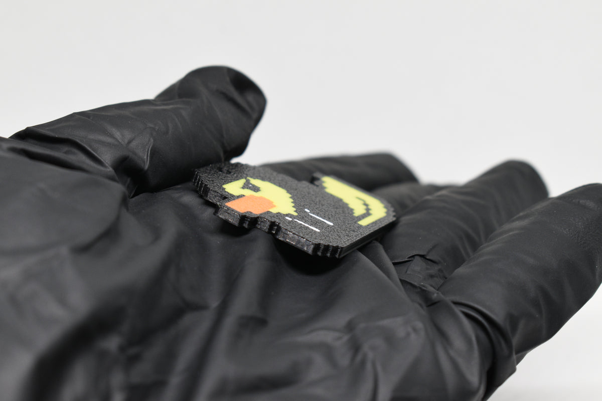 Side angle view showing 3D layered pixel detail and thickness of Hoodie Duck pixel rubber duck keychain by LayerPlay
