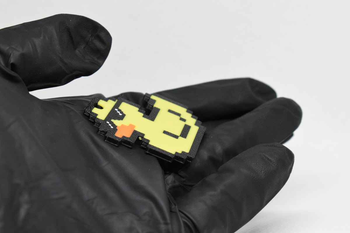 Side angle view showing 3D layered pixel detail and thickness of pixel rubber duck keychain by LayerPlay