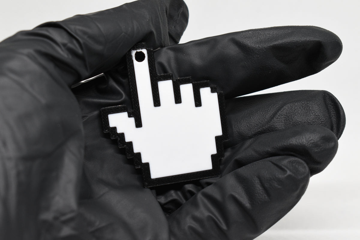 Hand in black glove holding 3D printed retro pixel pointing hand cursor keychain front view detail by LayerPlay