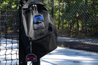 3D printed Pocket Motors mini car keychains clipped onto a black canvas backpack hanging outdoors by LayerPlay