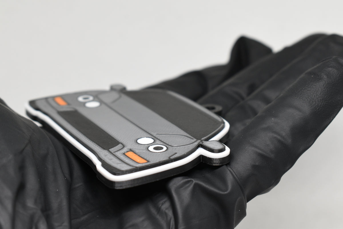 Side angle view showing 3D layered detail of light gray Acura Integra DC2 keychain by LayerPlay Pocket Motors