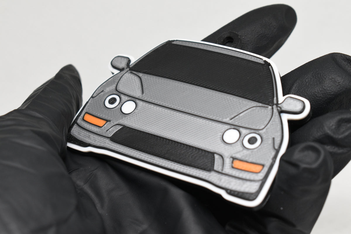 3D printed light gray Acura Integra DC2 keychain held in hand, front view detail by LayerPlay Pocket Motors