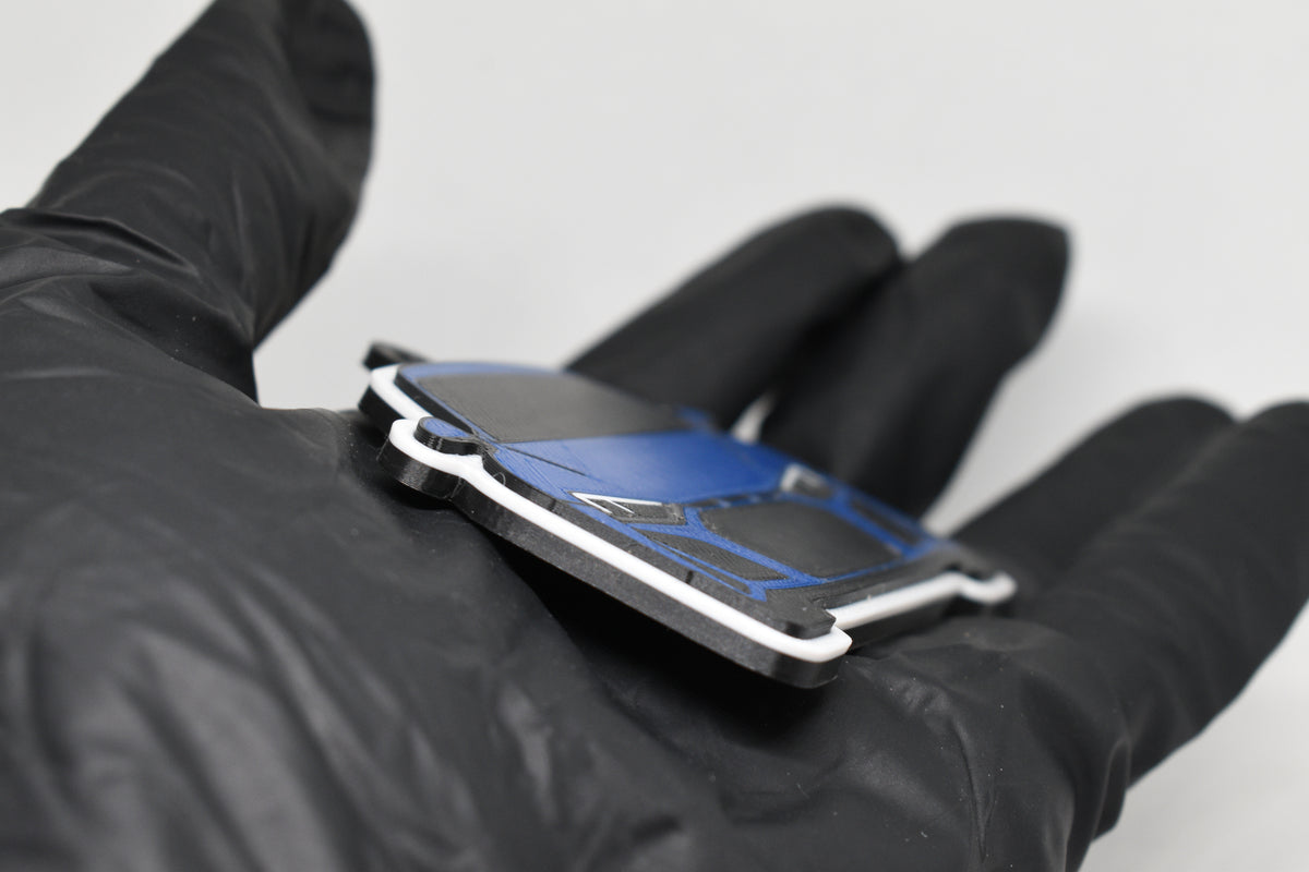 Side angle view showing 3D layered detail of blue Audi R8 keychain by LayerPlay Pocket Motors