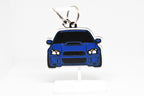 Pocket Motors Blobeye WRX STI keychain displayed on a white stand with metal ring and clip.