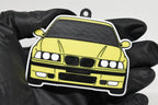 3D printed yellow BMW M3 E36 keychain held in hand, front view detail by LayerPlay Pocket Motors