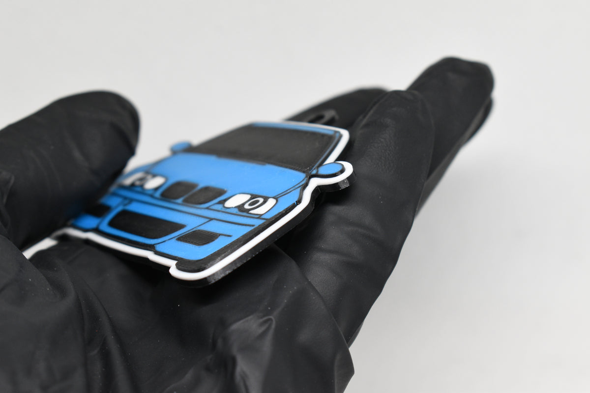 Side angle view showing 3D layered detail of light blue BMW M3 E46 keychain by LayerPlay Pocket Motors