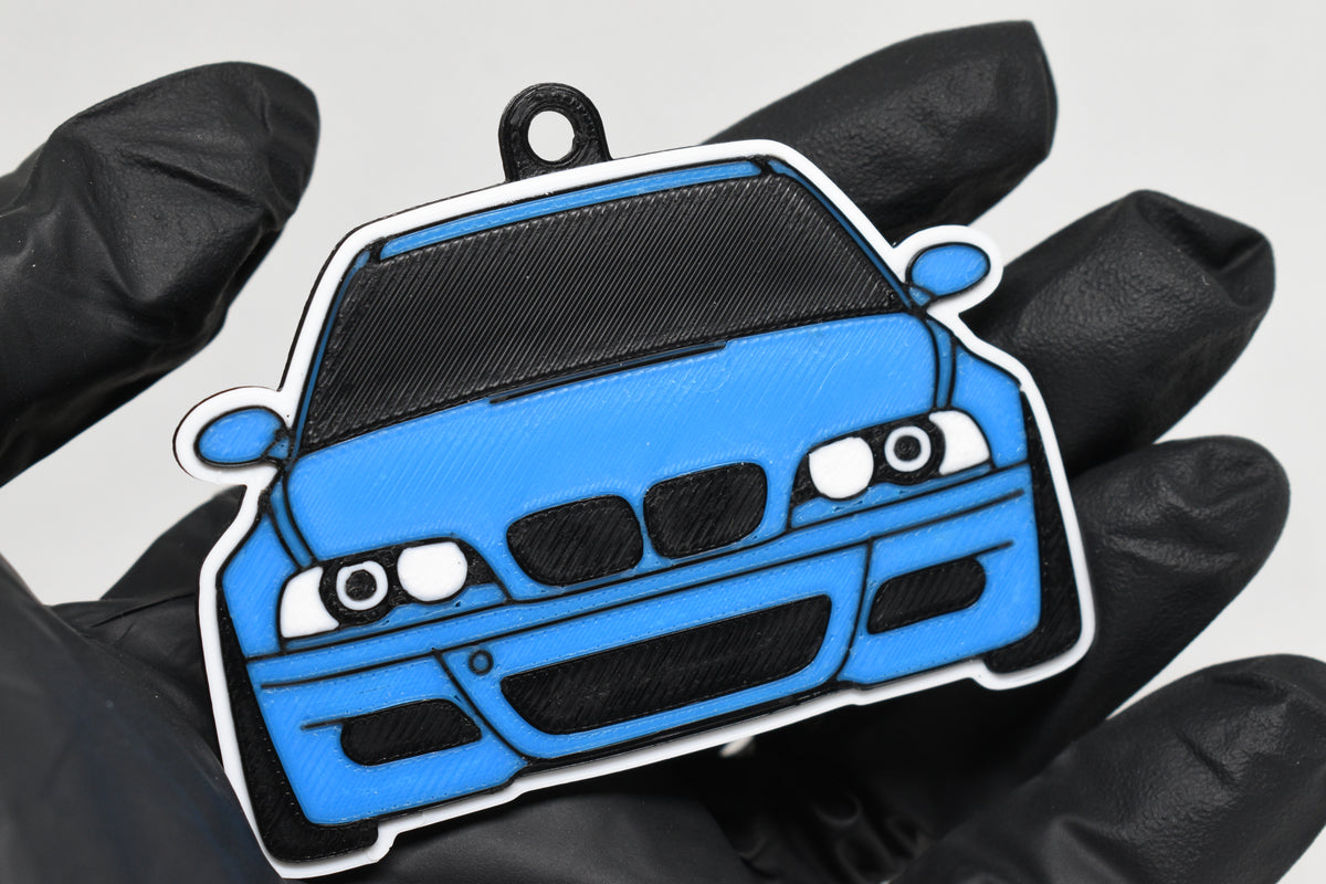 3D printed light blue BMW M3 E46 keychain held in hand, front view detail by LayerPlay Pocket Motors