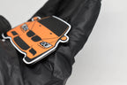 Side angle view showing 3D layered detail of orange BMW M3 E92 keychain by LayerPlay Pocket Motors