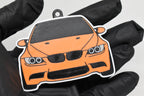 3D printed orange BMW M3 E92 keychain held in hand, front view detail by LayerPlay Pocket Motors